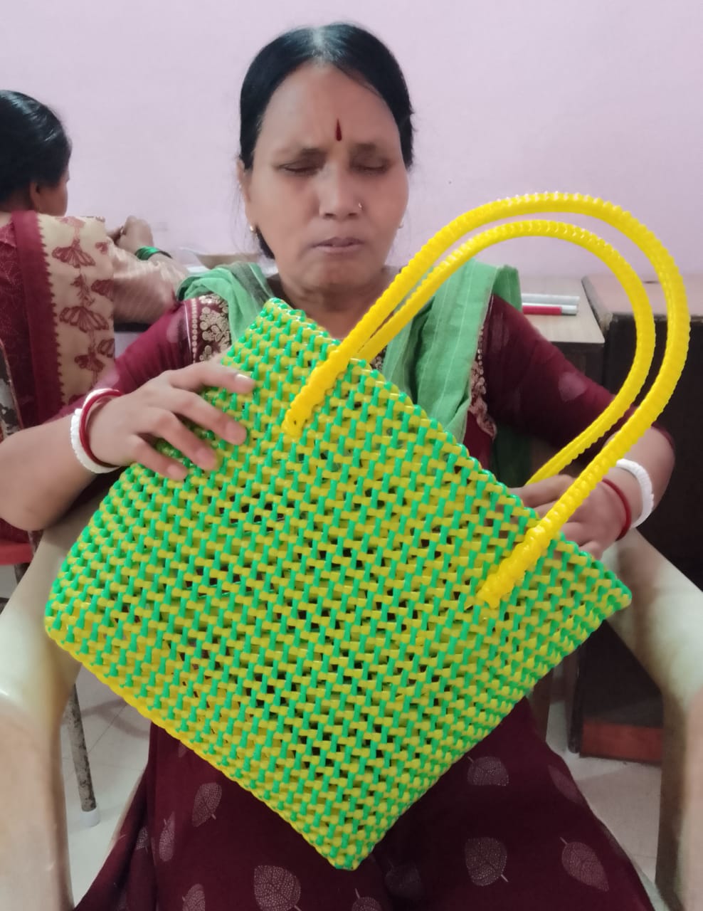Artisan working on a woven bag